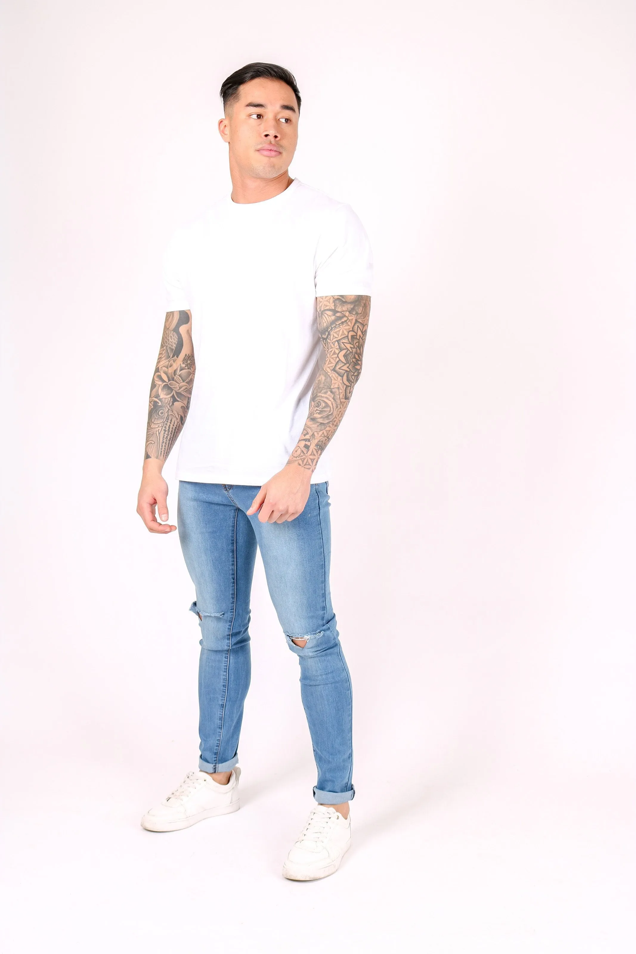 Logan Skinny Stretch Jeans In Light Stonewash With Ripped Knee